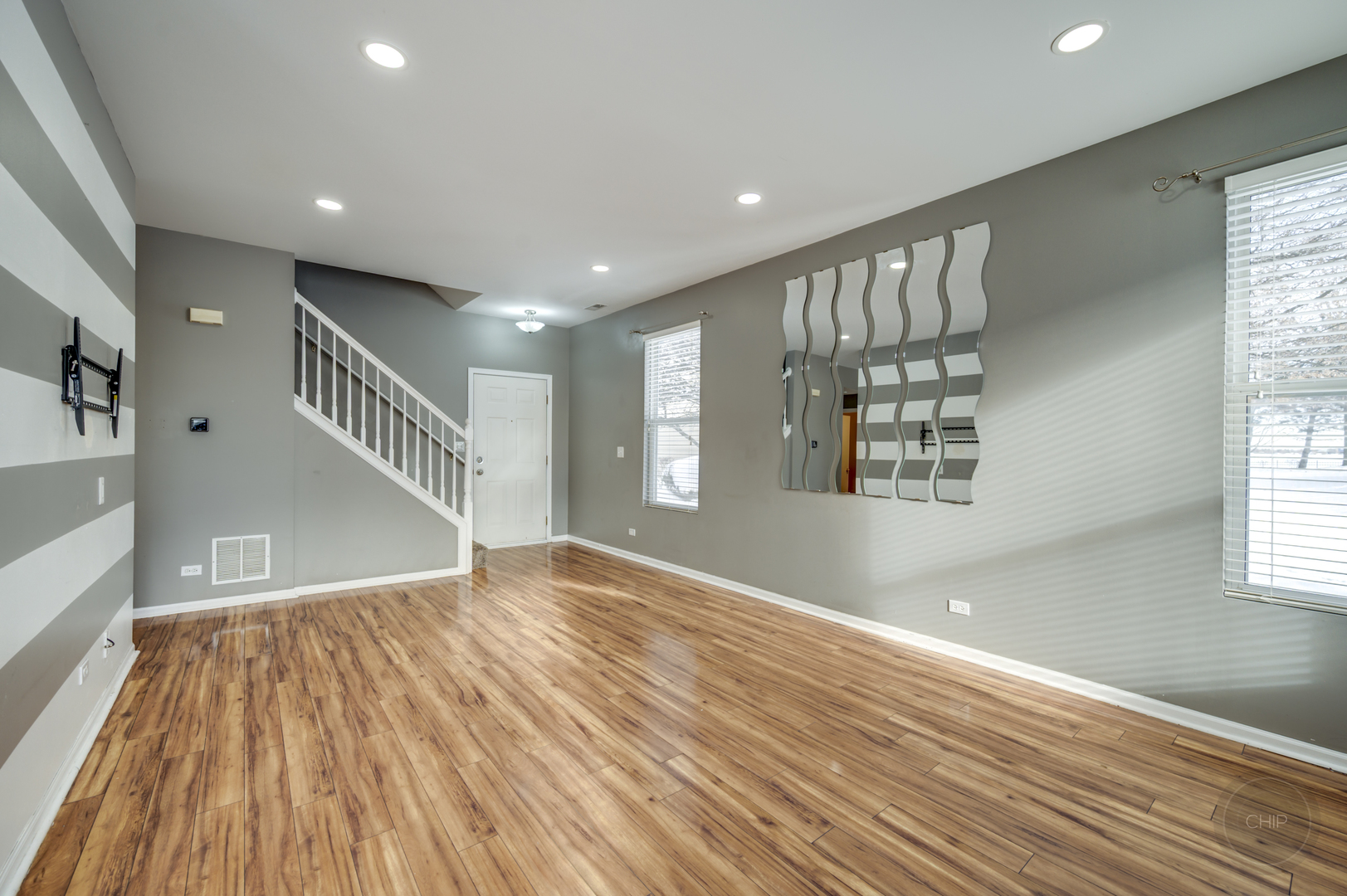 4055 Blackstone Drive, Unit 4055 Aurora, IL 60504 - Photo 6 of 43 a view of an empty room with wooden floor and a window