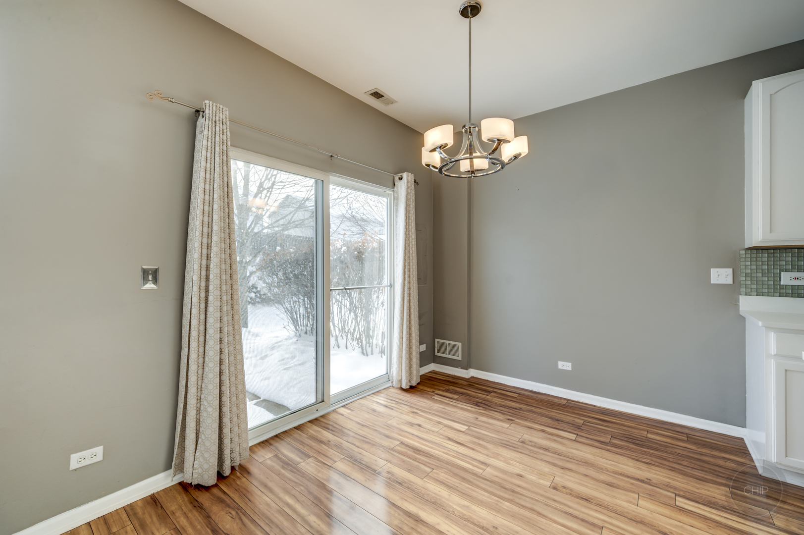 4055 Blackstone Drive, Unit 4055 Aurora, IL 60504 - Photo 8 of 43 a view of a livingroom with a chandelier wooden floor and a chandelier