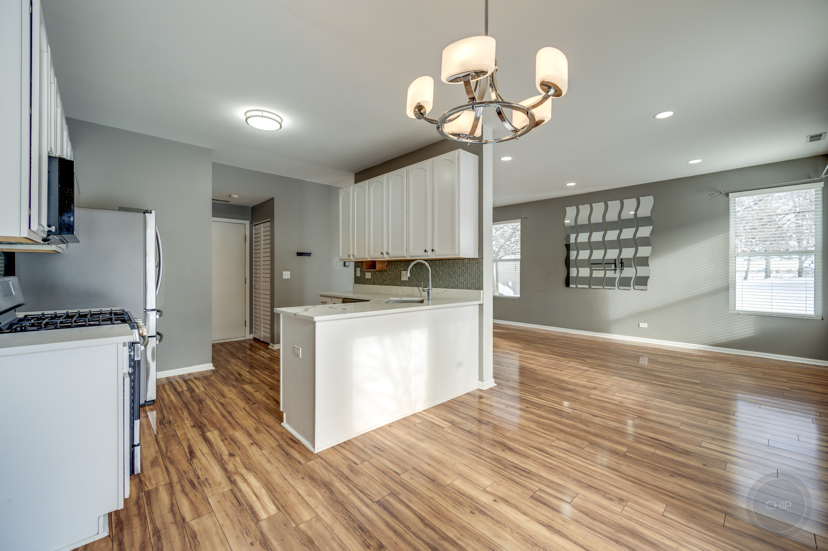 4055 Blackstone Drive, Unit 4055 Aurora, IL 60504 - Photo 9 of 43 a kitchen with kitchen island stainless steel appliances a stove center island a refrigerator and cabinets
