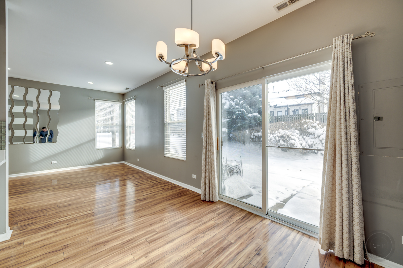 4055 Blackstone Drive, Unit 4055 Aurora, IL 60504 - Photo 10 of 43 a view of an empty room with wooden floor and a window