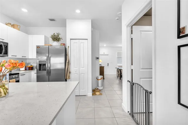 a kitchen with stainless steel appliances a refrigerator and a sink
