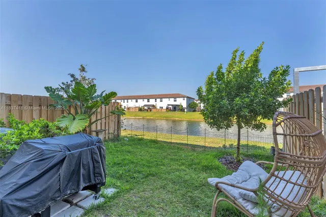 a view of a backyard with sitting area