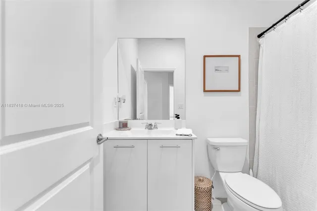 a white toilet sitting next to a bathroom sink