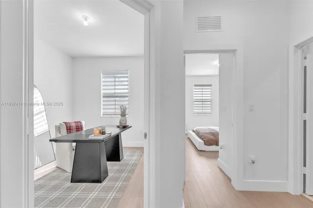 a room with a window and flowerpot