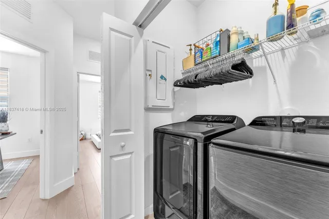 a kitchen with stainless steel appliances granite countertop a sink a stove and a refrigerator