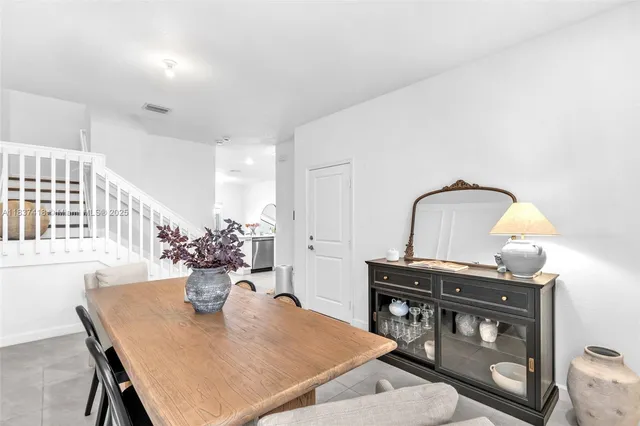 a view of a dining room with furniture and chandelier