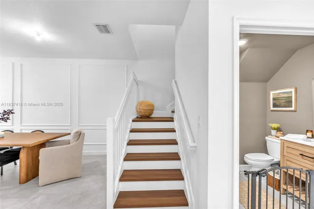 a view of a hallway with furniture and entryway