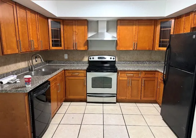a kitchen with a stove a sink and a refrigerator
