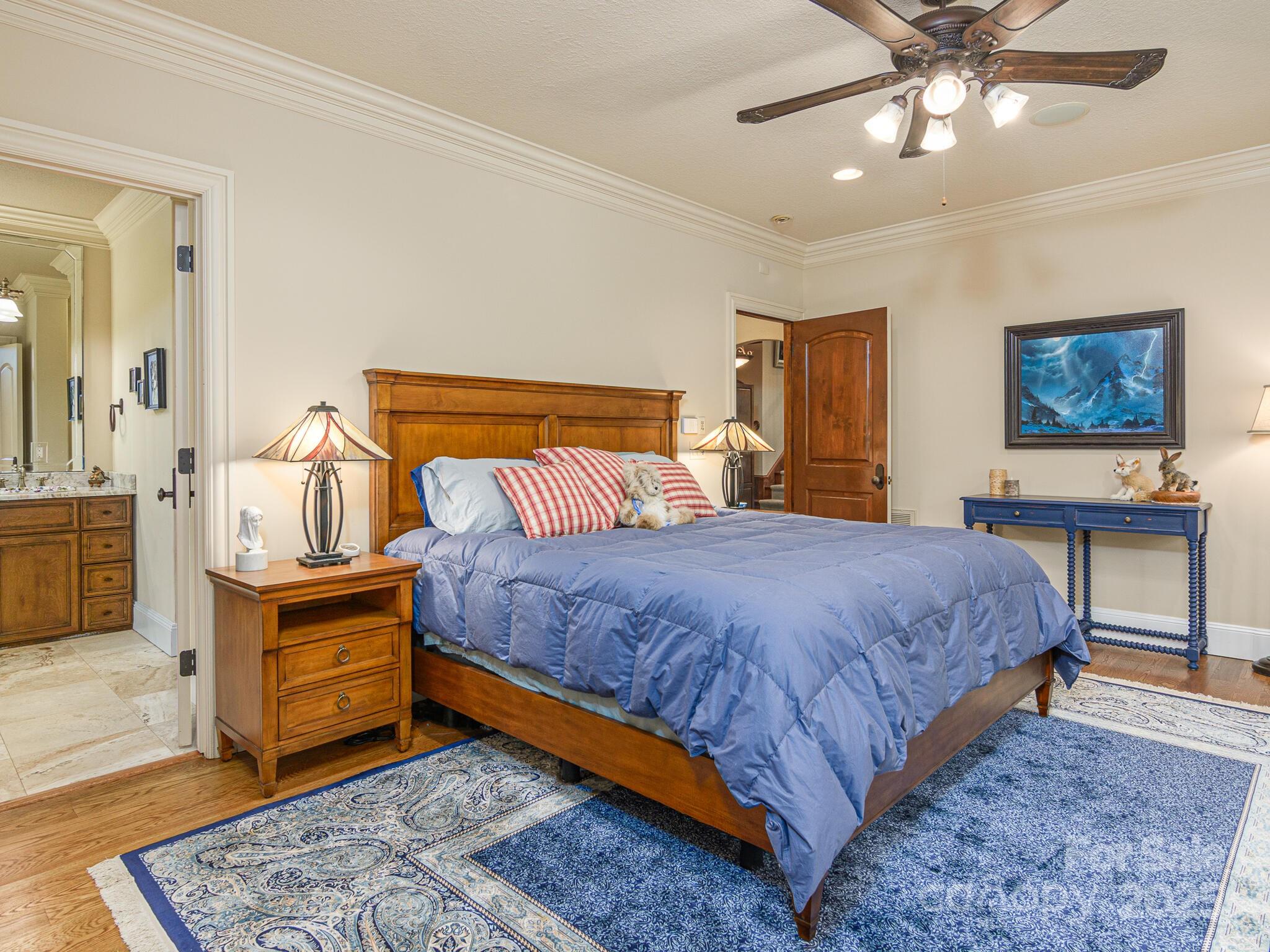 176 Valley Springs Road Asheville, NC 28803 - Photo 16 of 48 a bedroom with a bed and a chandelier