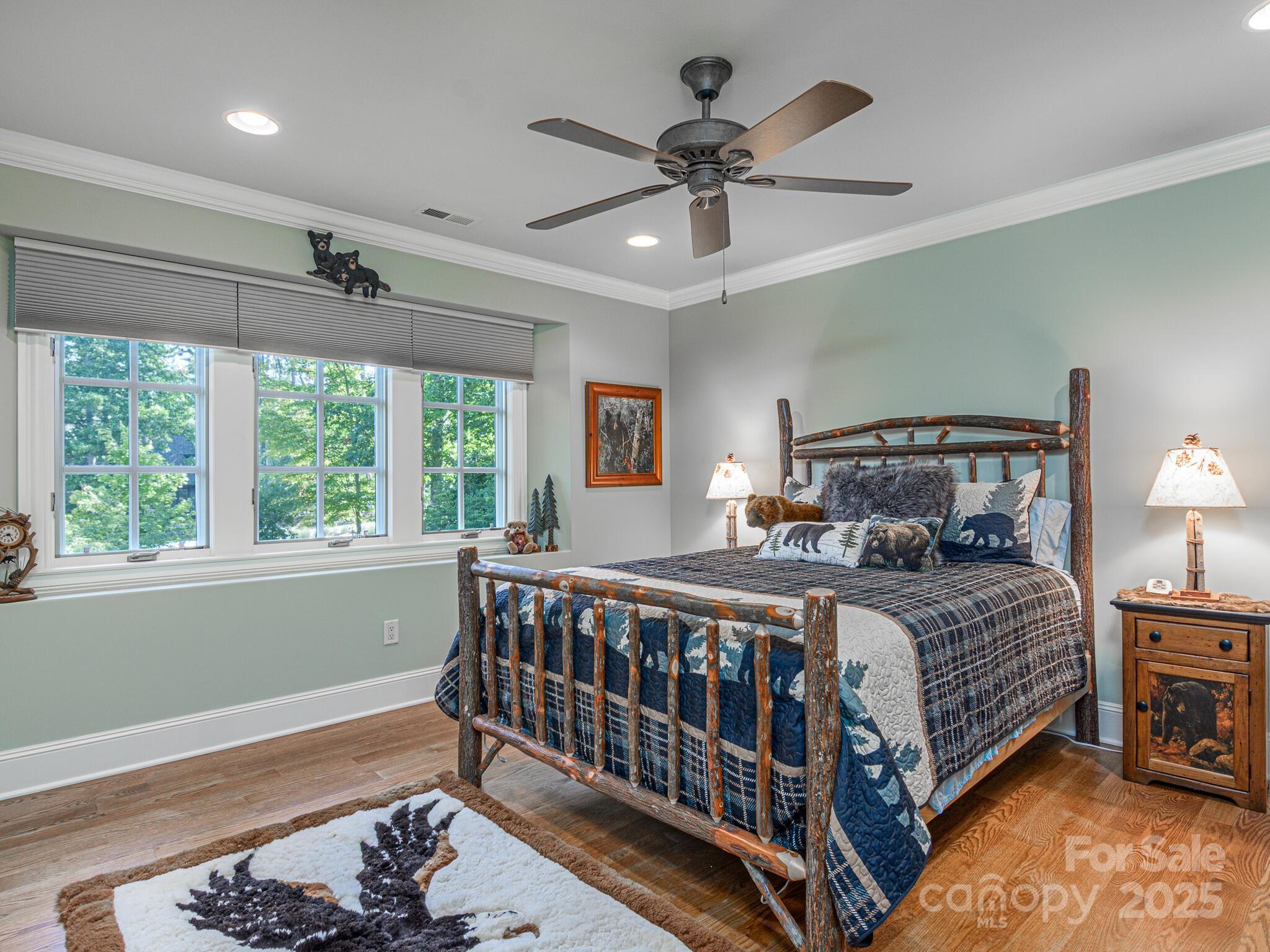 176 Valley Springs Road Asheville, NC 28803 - Photo 25 of 48 a bedroom with a bed a large window and a chandelier