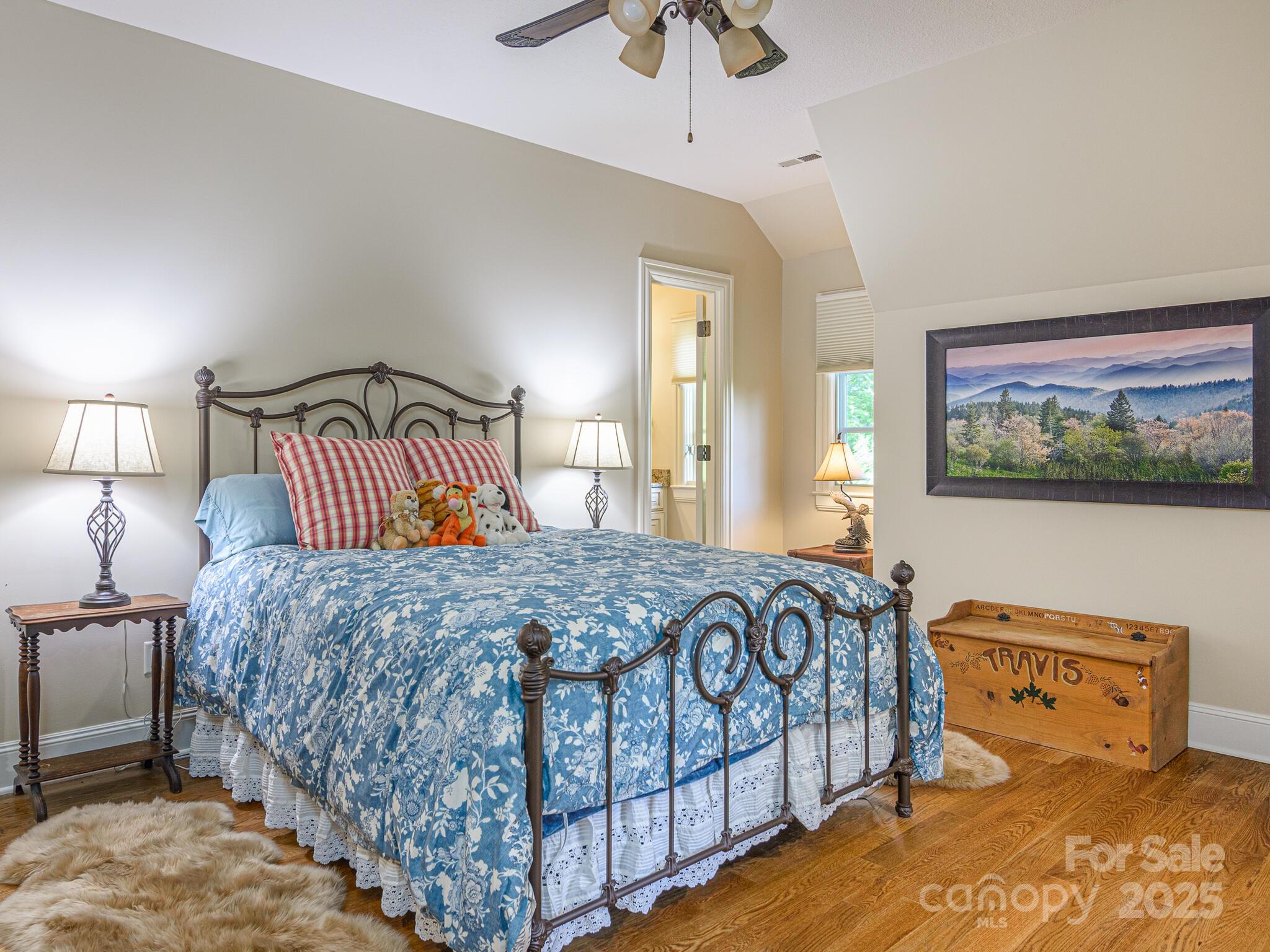 176 Valley Springs Road Asheville, NC 28803 - Photo 33 of 48 a bedroom with a bed and a chandelier