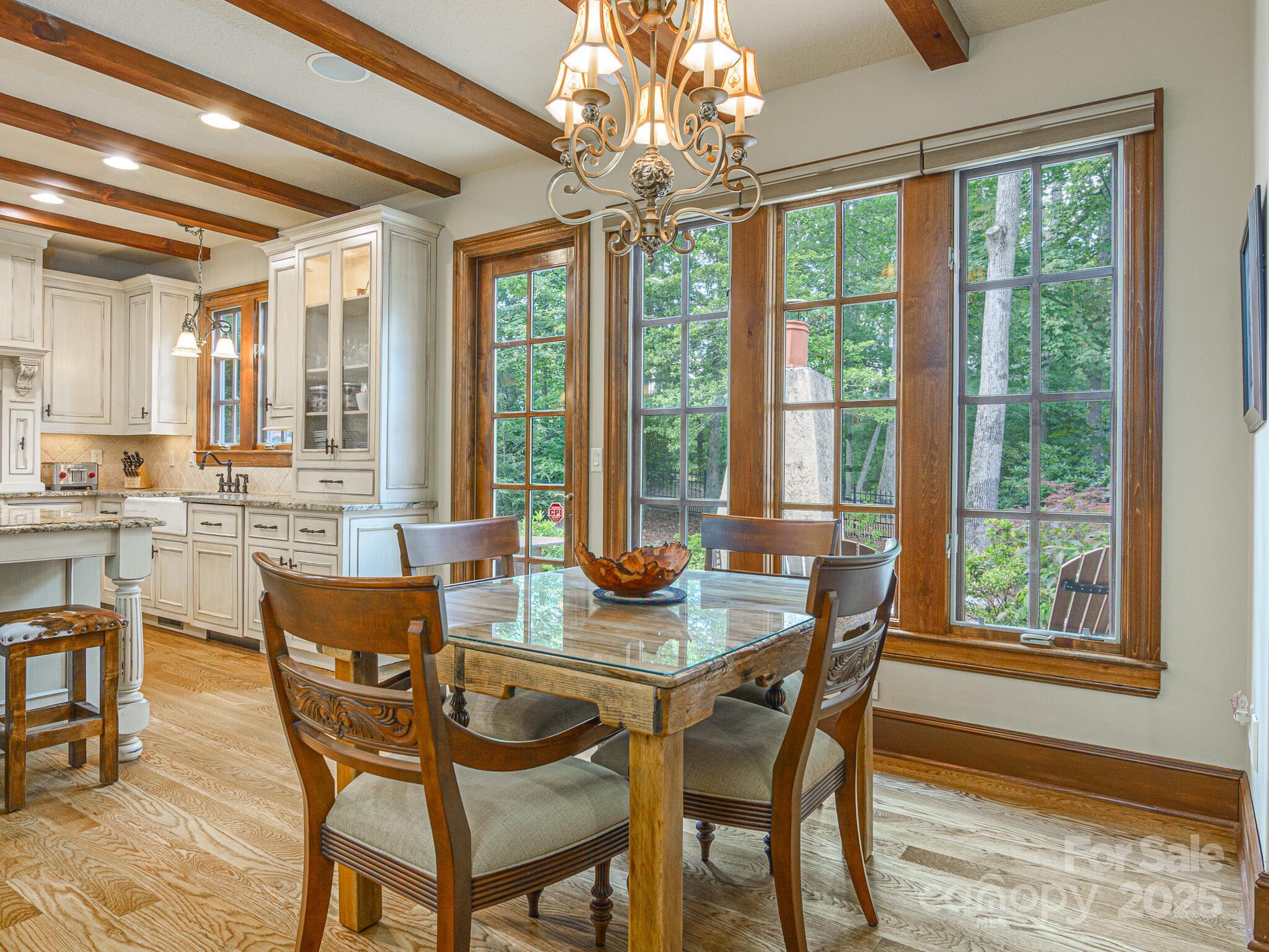 176 Valley Springs Road Asheville, NC 28803 - Photo 7 of 48 a view of a dining room with furniture large windows and wooden floor