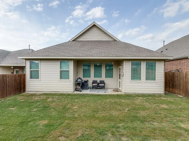 a front view of house with yard outdoor seating and barbeque oven