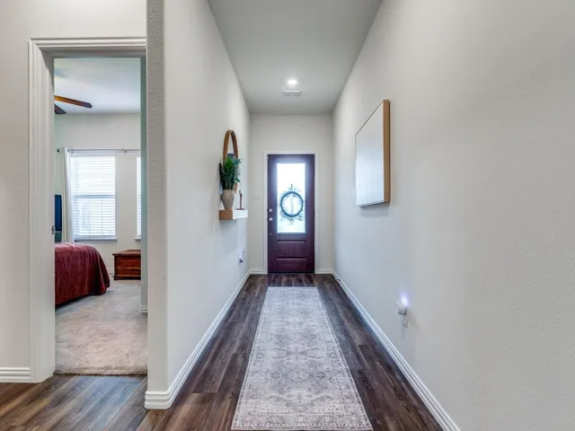 a view of a hallway view with wooden floor and furniture