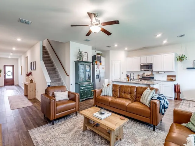 a living room with furniture and wooden floor