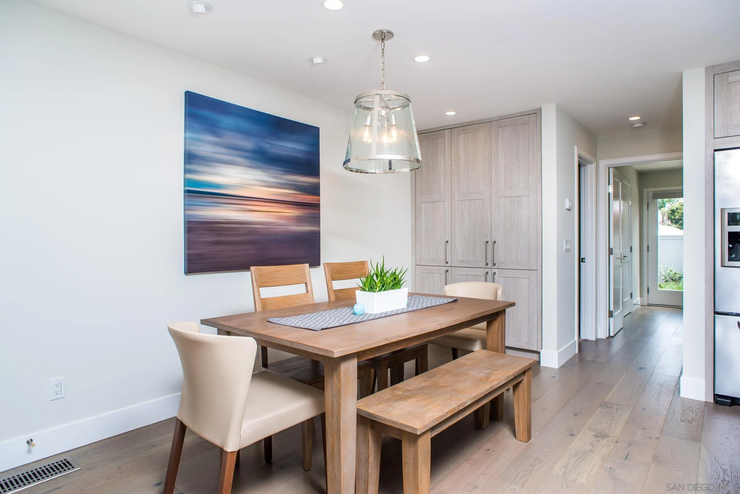 129 West Jason Street Encinitas, CA 92024 - Photo 17 of 44 a view of a dining room with furniture wooden floor and chandelier