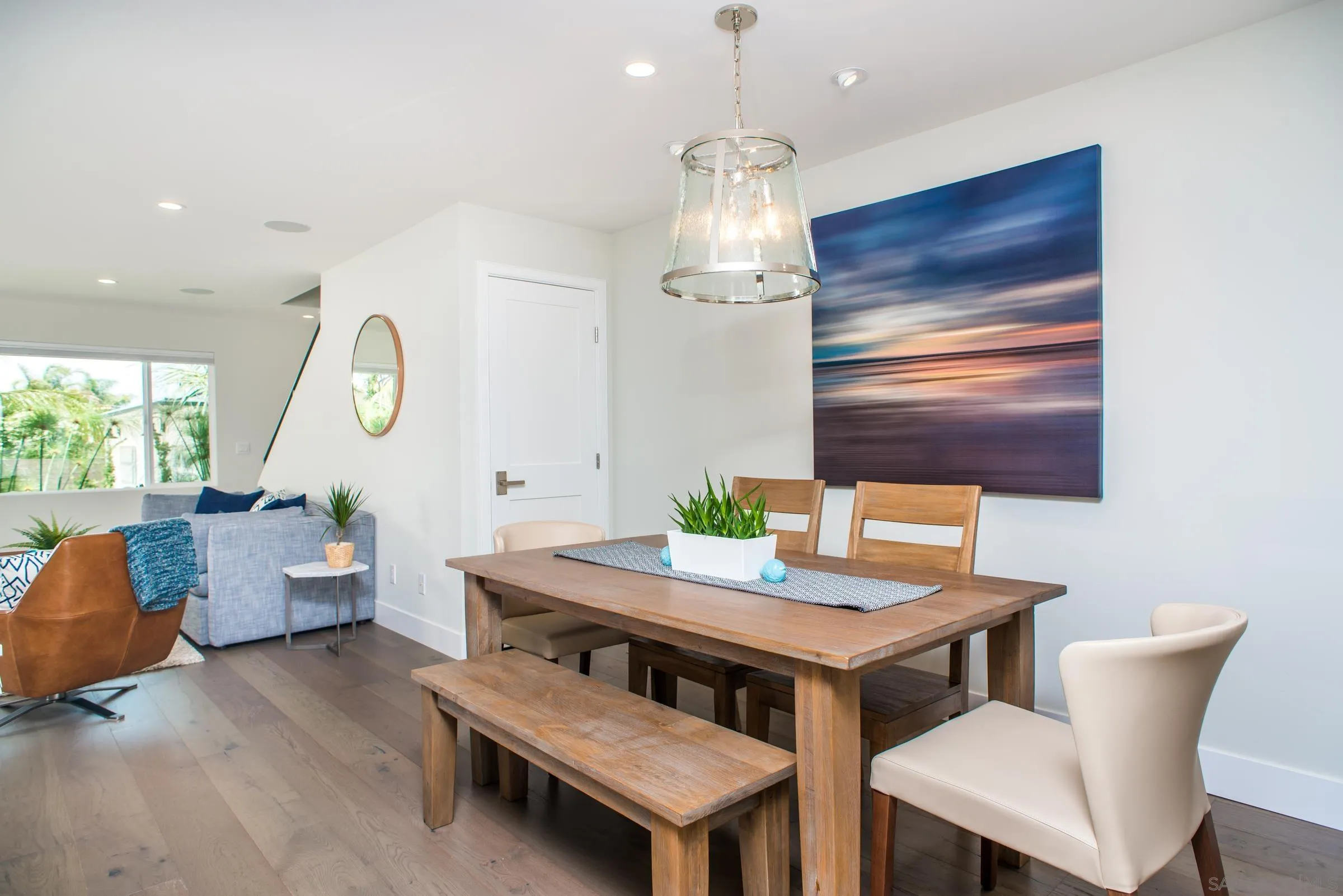129 West Jason Street Encinitas, CA 92024 - Photo 18 of 44 a view of a dining room with furniture a livingroom and chandelier