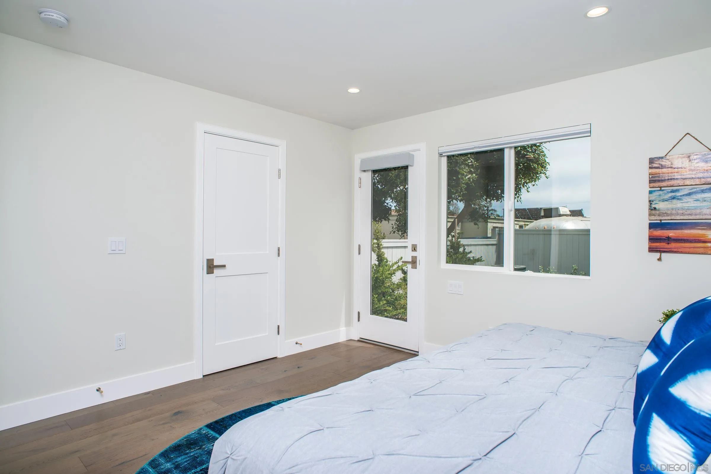 129 West Jason Street Encinitas, CA 92024 - Photo 22 of 44 a bedroom with a bed and a large window