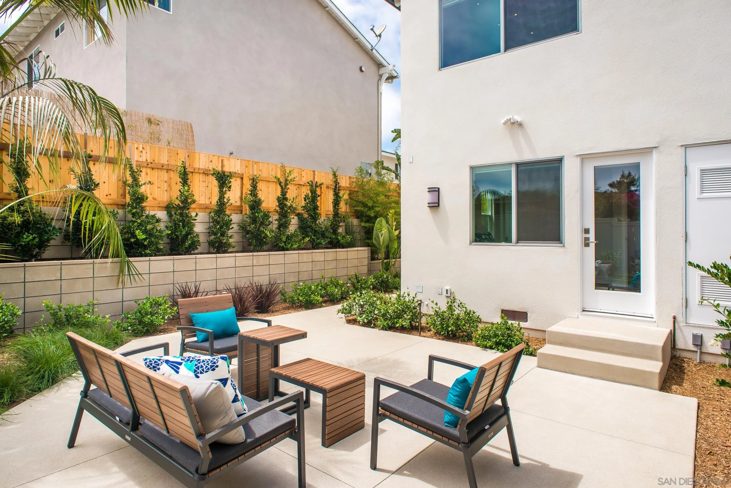 129 West Jason Street Encinitas, CA 92024 - Photo 28 of 44 a view of a patio with couches table and chairs and potted plants
