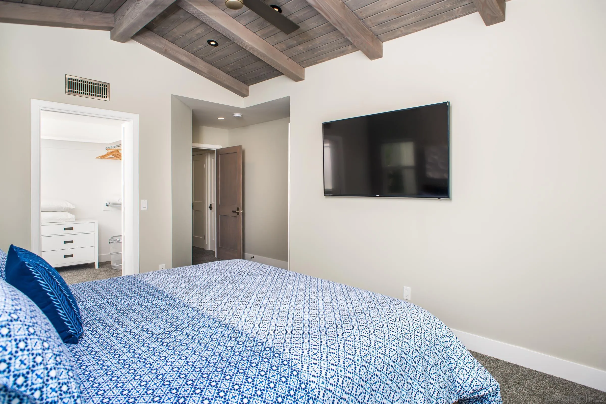 129 West Jason Street Encinitas, CA 92024 - Photo 33 of 44 a bedroom with a bed and a flat screen tv