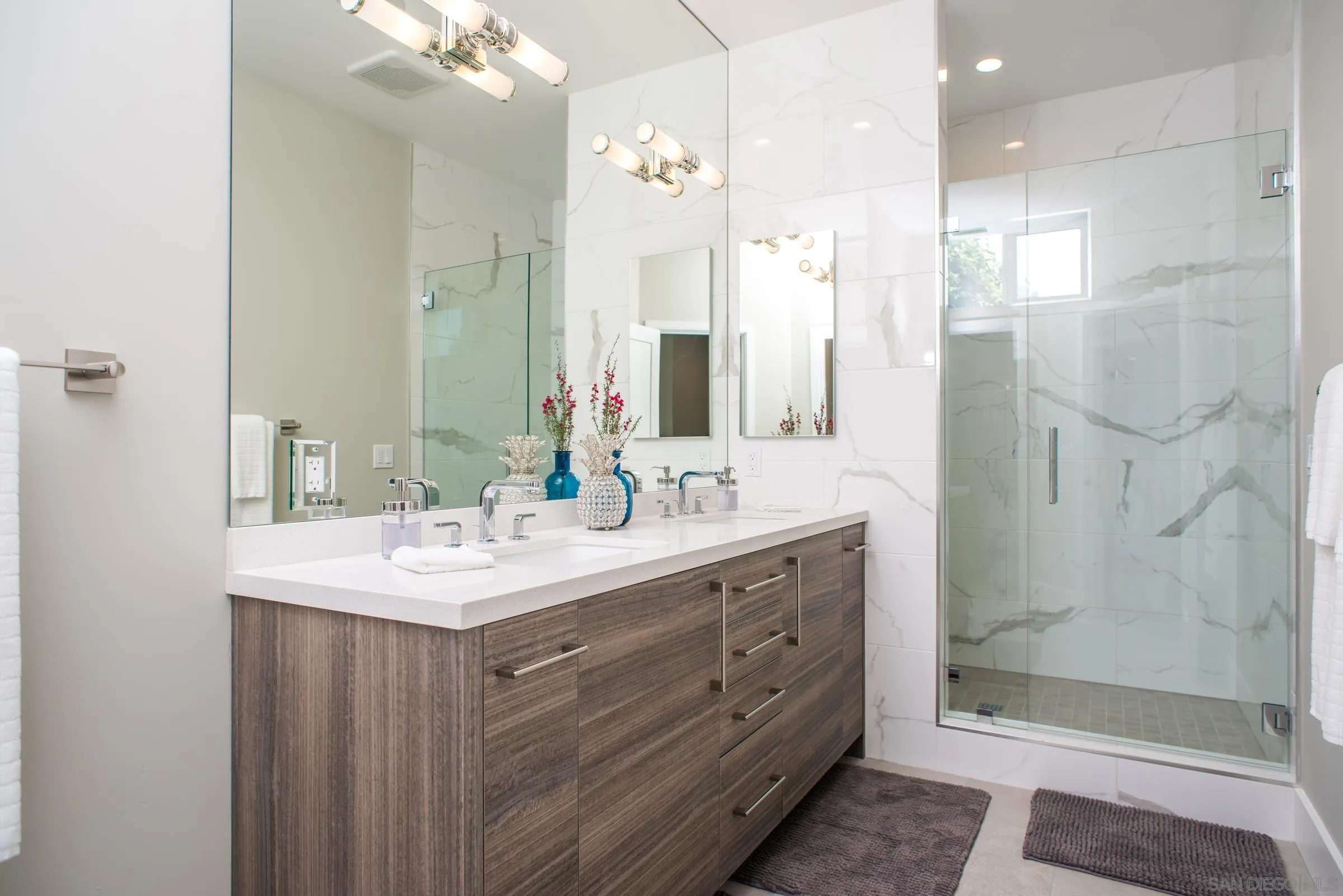 129 West Jason Street Encinitas, CA 92024 - Photo 38 of 44 a bathroom with a sink vanity granite shower and a mirror