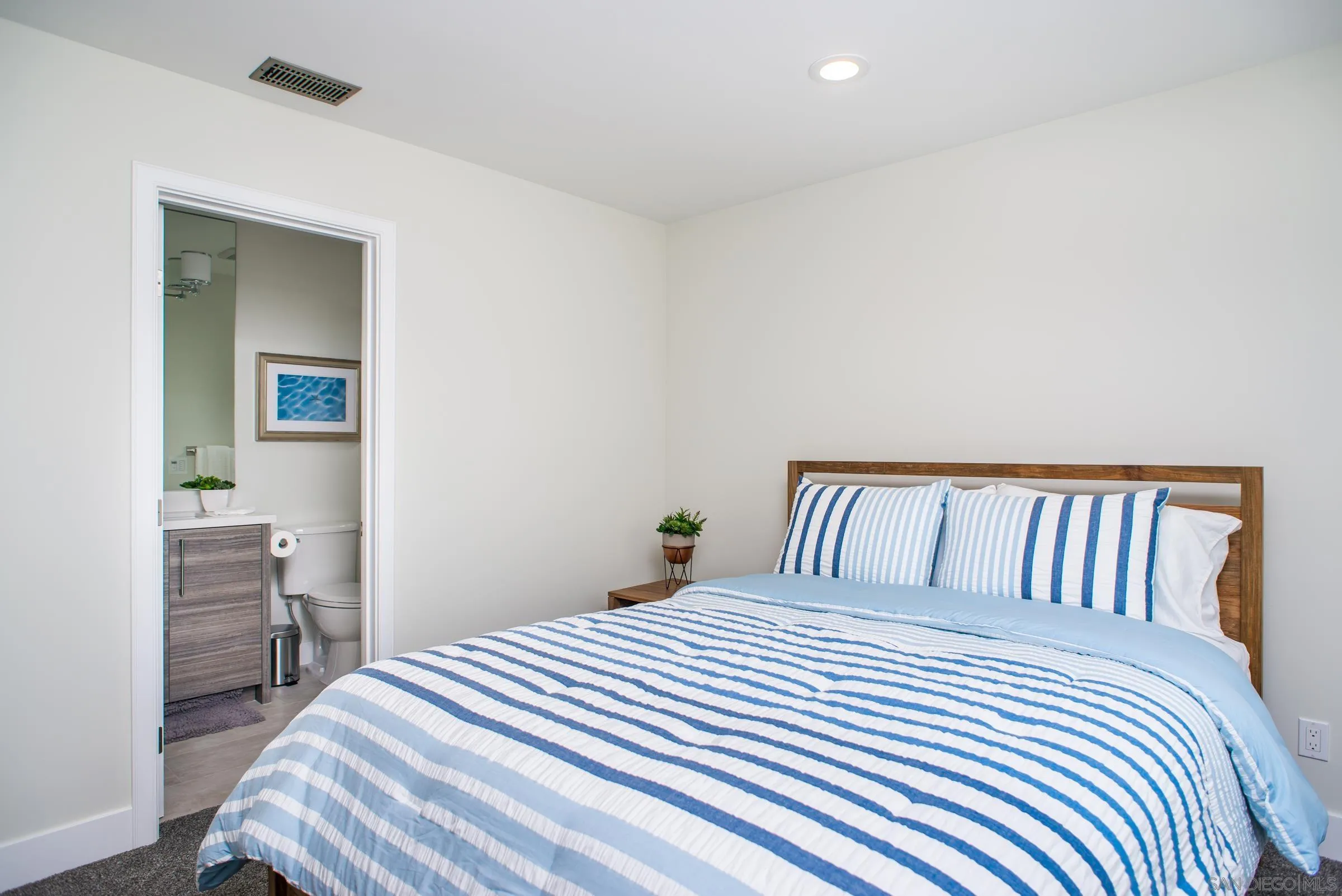 129 West Jason Street Encinitas, CA 92024 - Photo 39 of 44 a bedroom with a bed and a table