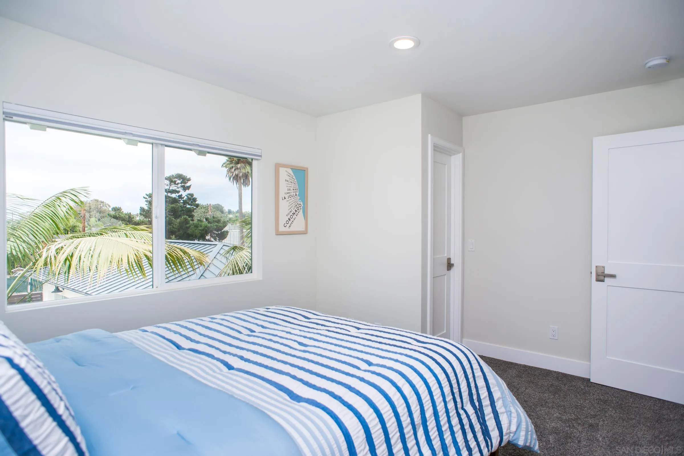 129 West Jason Street Encinitas, CA 92024 - Photo 40 of 44 a bedroom with a bed and a large window