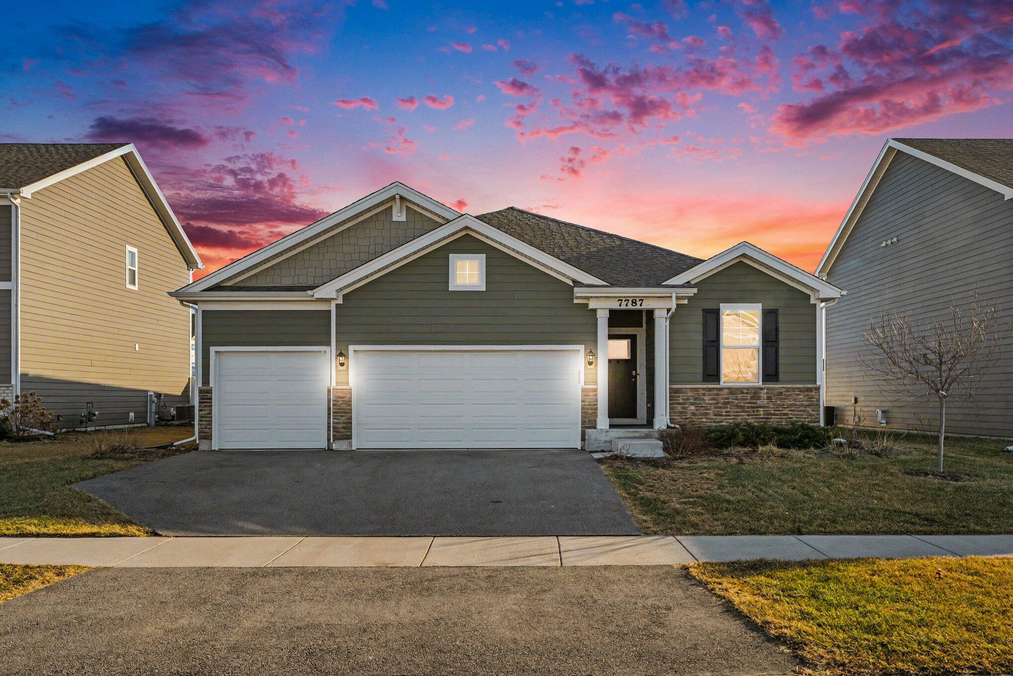 a front view of a house with a yard and garage
