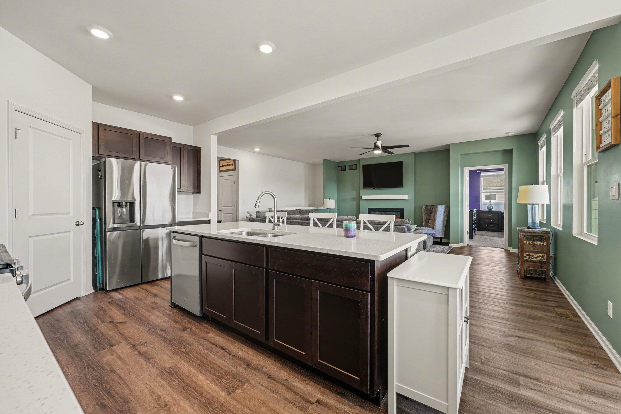 7787 West 105th Place Crown Point, IN 46307 - Photo 11 of 32 a kitchen with stainless steel appliances granite countertop a sink stove and refrigerator