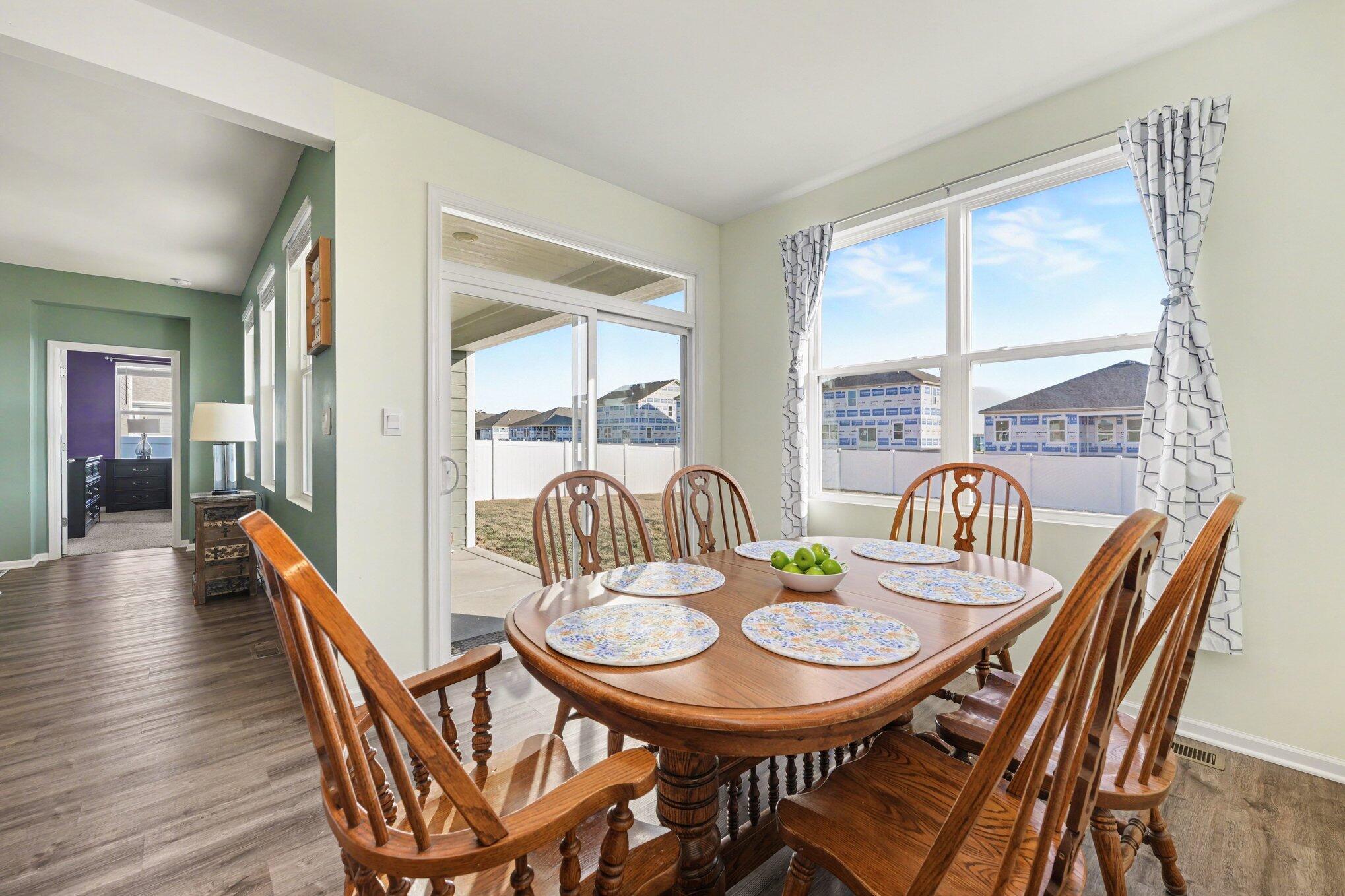 7787 West 105th Place Crown Point, IN 46307 - Photo 13 of 32 a view of a dining room with furniture window and wooden floor