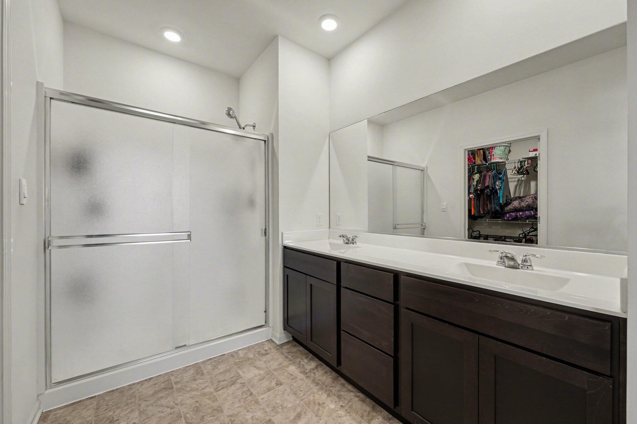 7787 West 105th Place Crown Point, IN 46307 - Photo 17 of 32 a bathroom with a double vanity sink mirror and shower