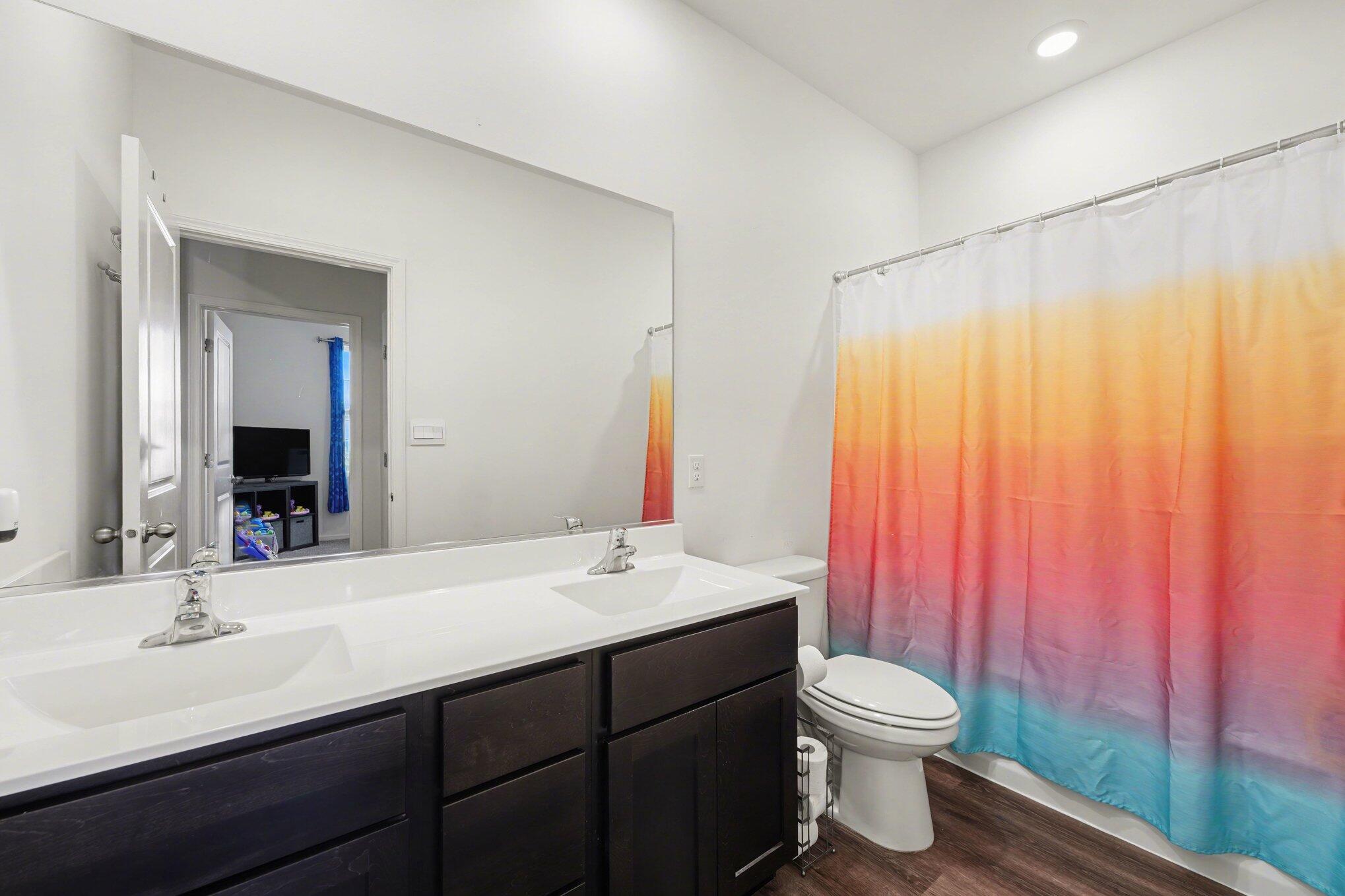 7787 West 105th Place Crown Point, IN 46307 - Photo 20 of 32 a bathroom with a double vanity sink toilet and a mirror