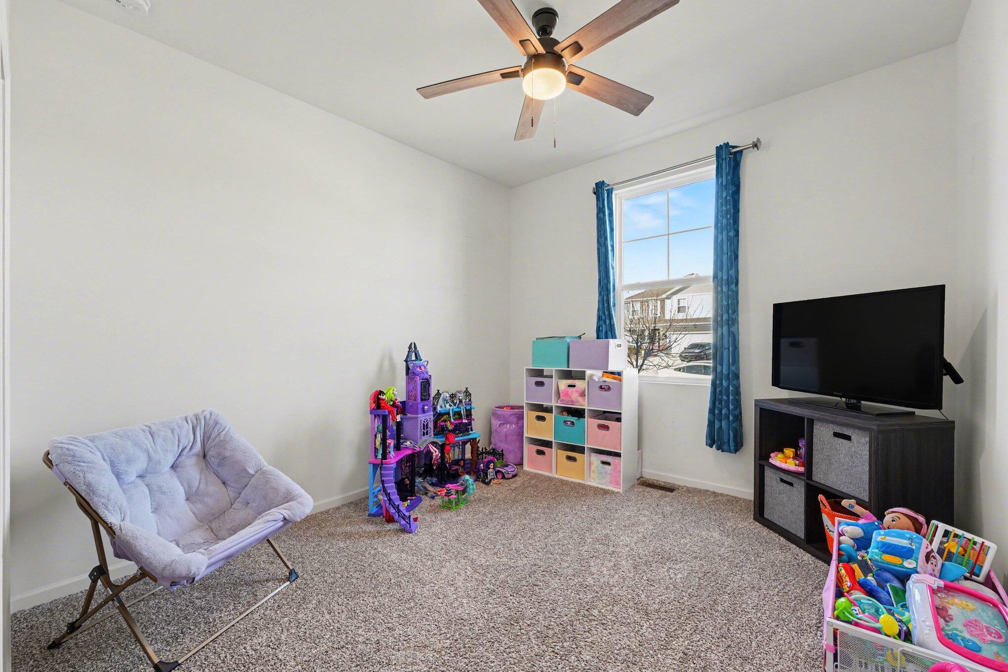 7787 West 105th Place Crown Point, IN 46307 - Photo 21 of 32 a view of a workspace with furniture and a flat screen tv