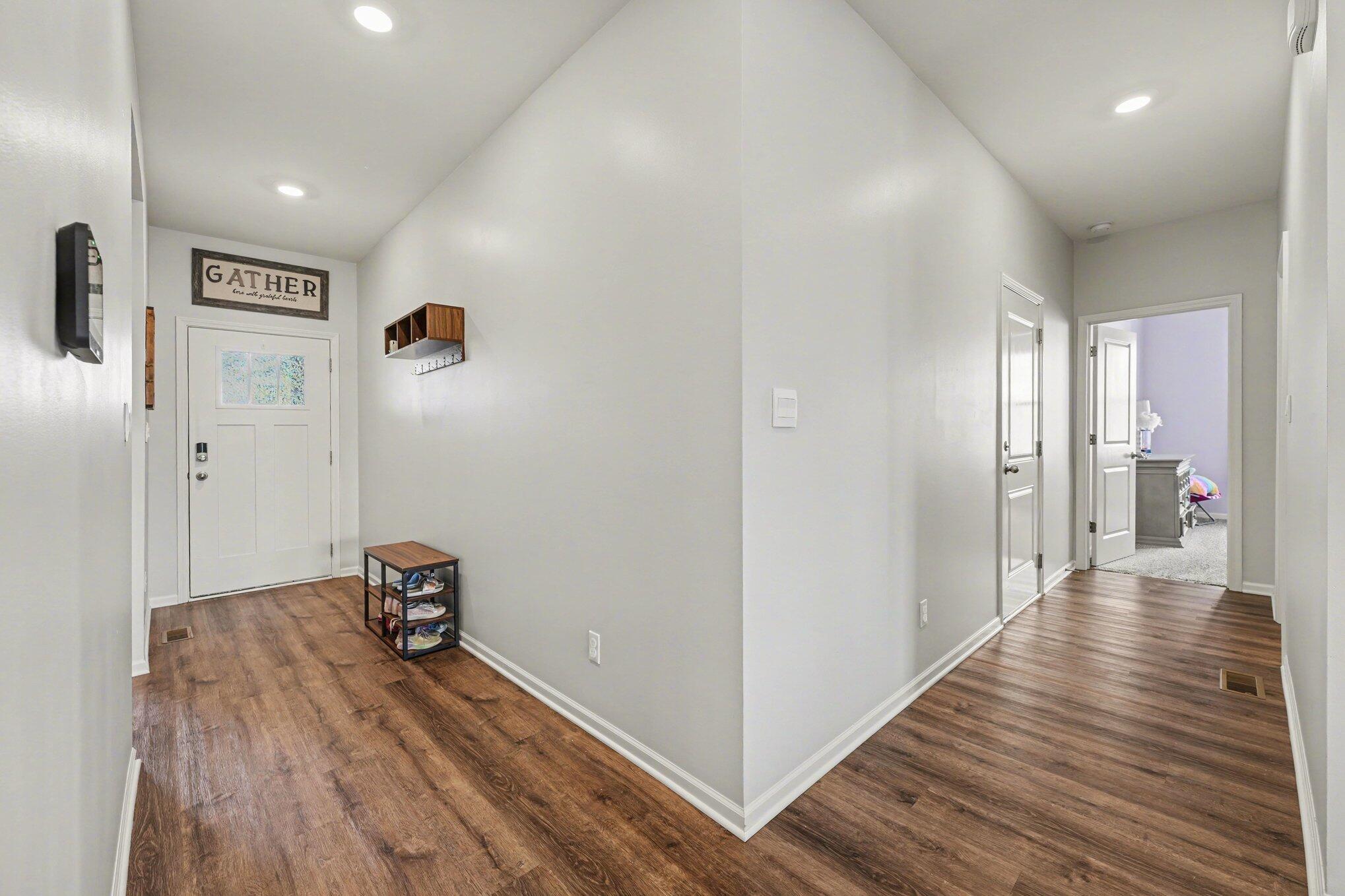 7787 West 105th Place Crown Point, IN 46307 - Photo 4 of 32 a view of hallway with wooden floor