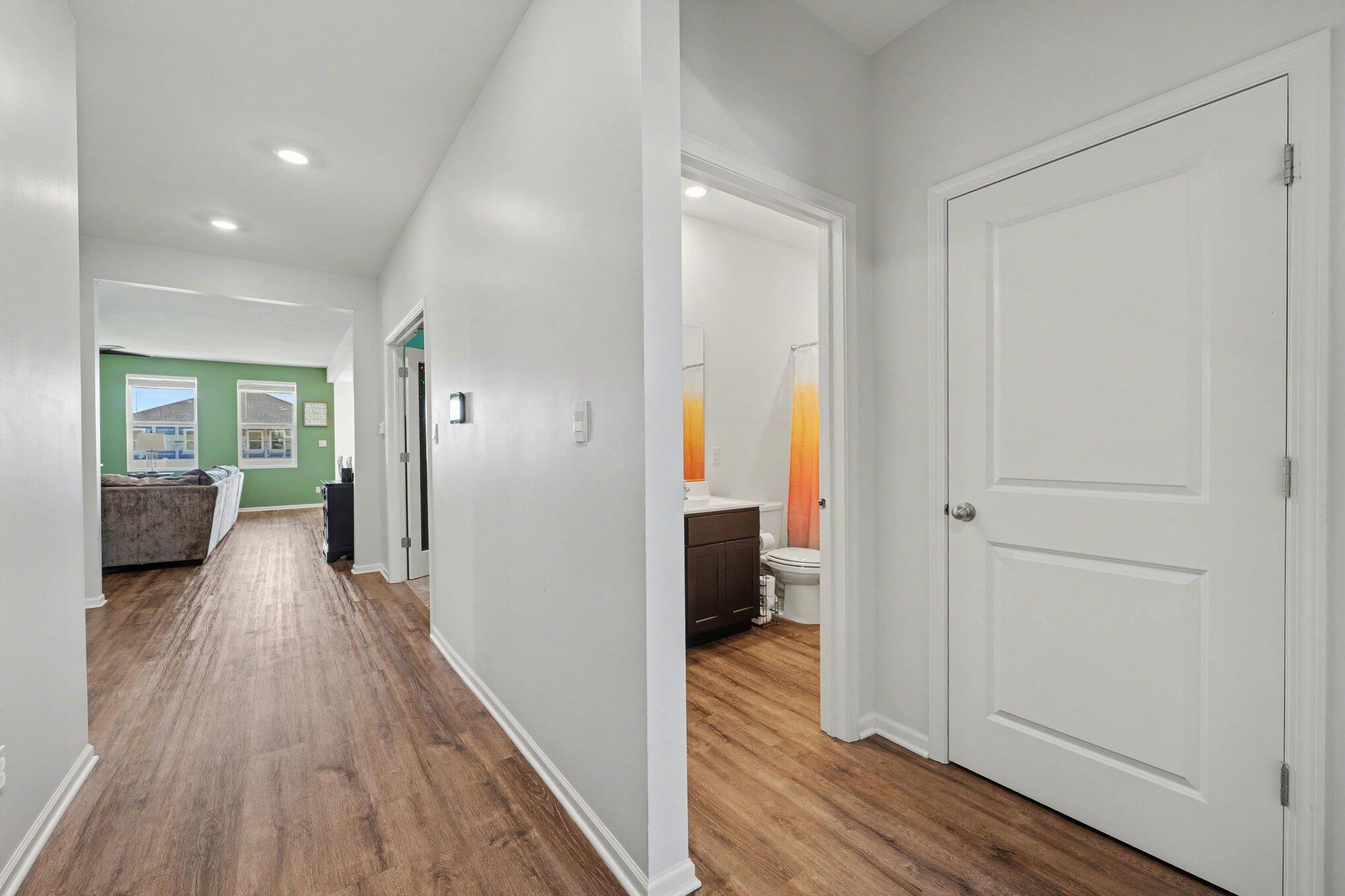 7787 West 105th Place Crown Point, IN 46307 - Photo 5 of 32 a view of a hallway with wooden floor and a bedroom