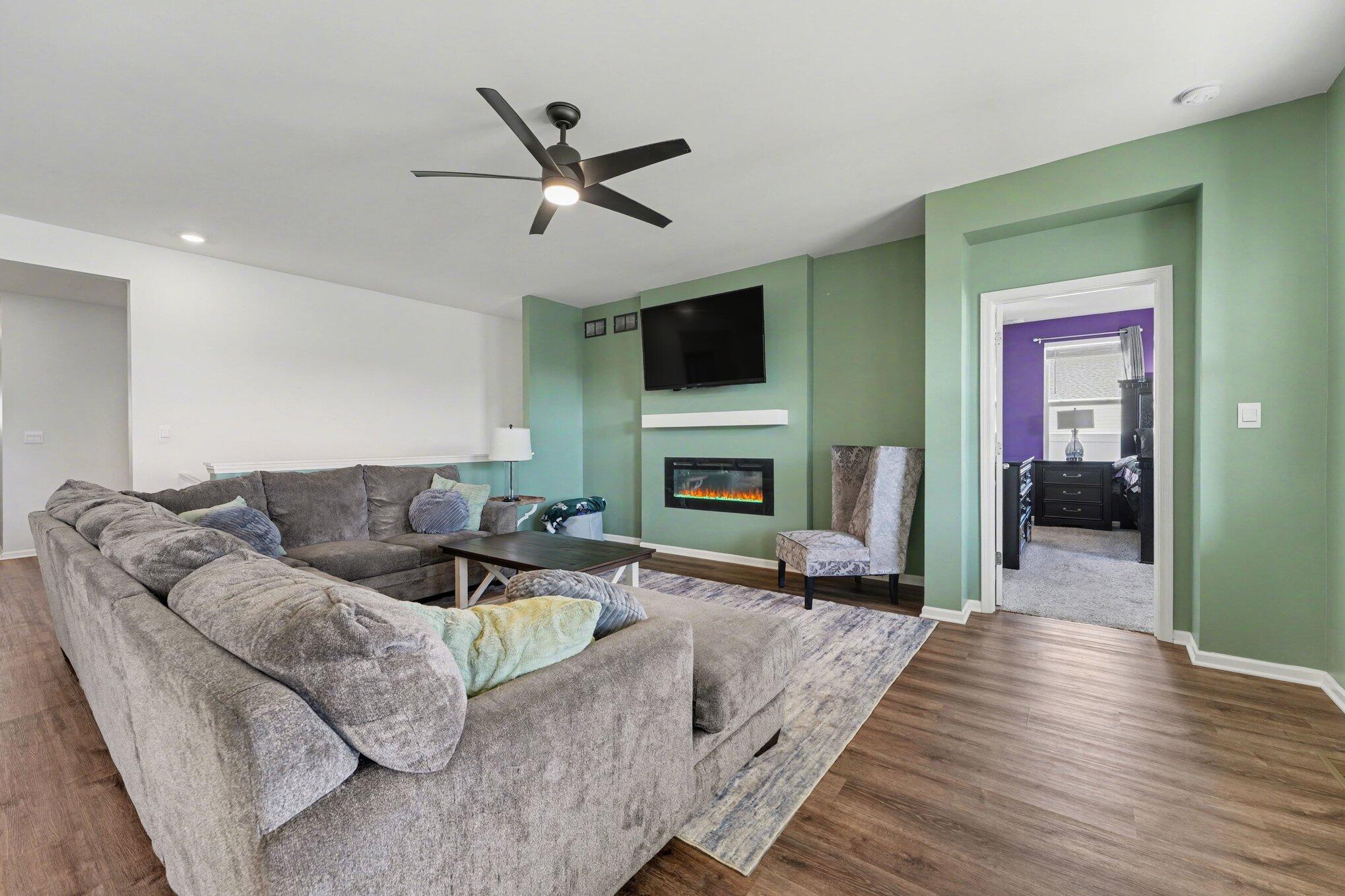 7787 West 105th Place Crown Point, IN 46307 - Photo 7 of 32 a living room with furniture fireplace and a flat screen tv
