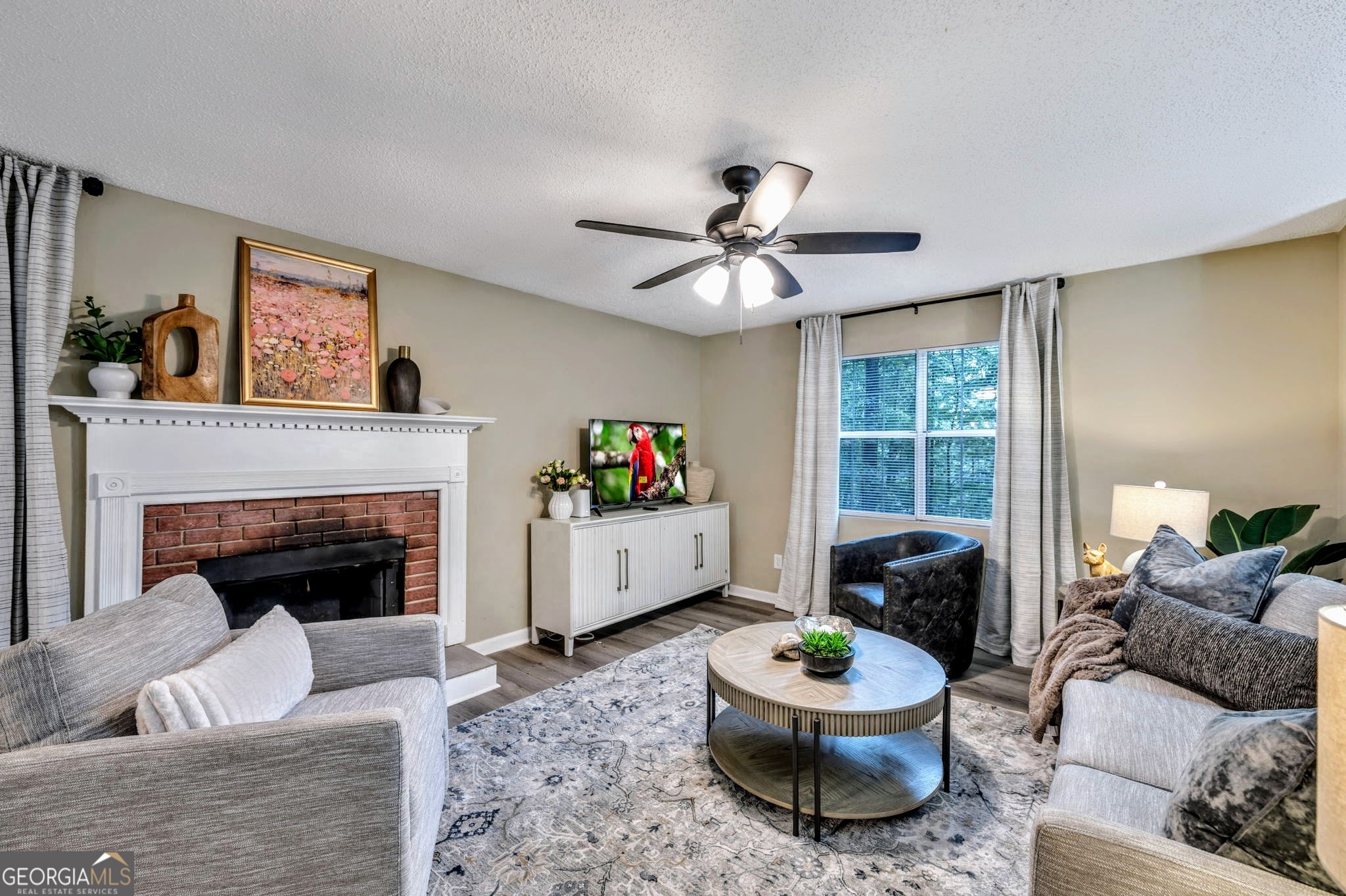 a living room with furniture and a fireplace