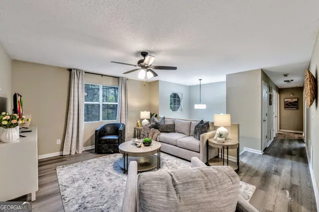 a living room with furniture and a large window