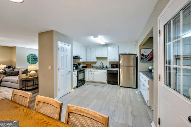 a kitchen with stainless steel appliances a refrigerator and a stove top oven