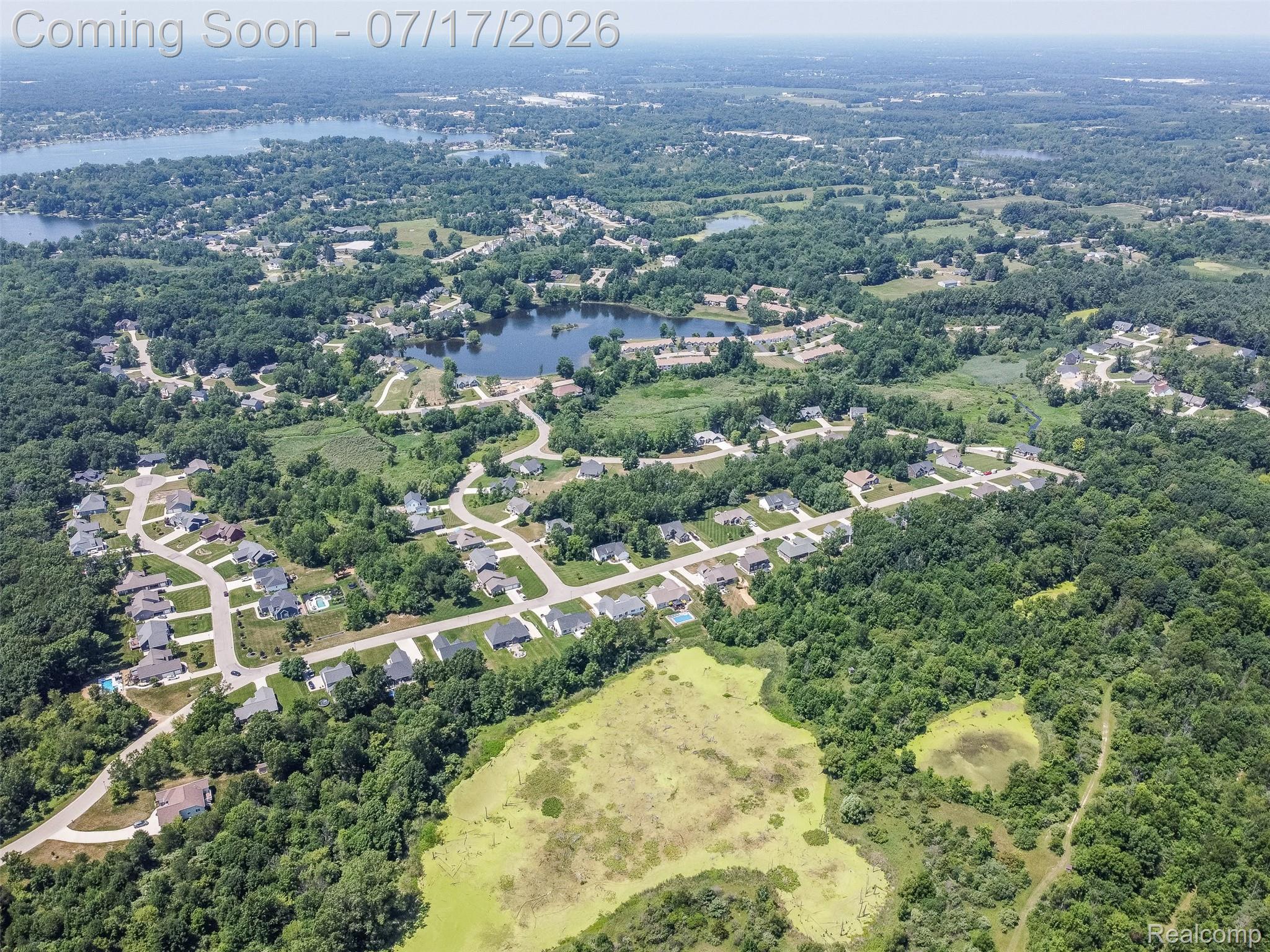 12349 Sugar Maple Drive Fenton, MI 48430 - Photo 65 of 67 Aerial perspective showcasing a residential development surrounded by mature trees
