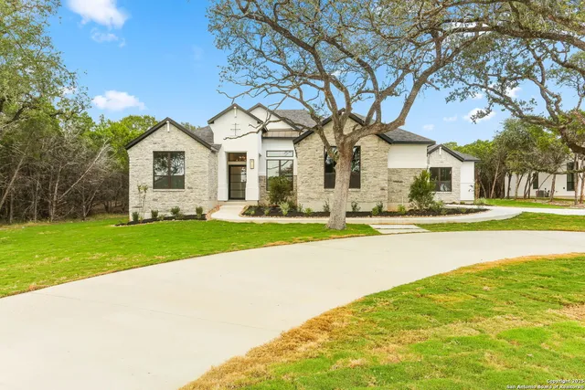 a front view of house with yard and green space