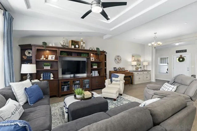 a living room with furniture a large window and a flat screen tv