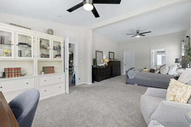 a bedroom with a bed and a chair