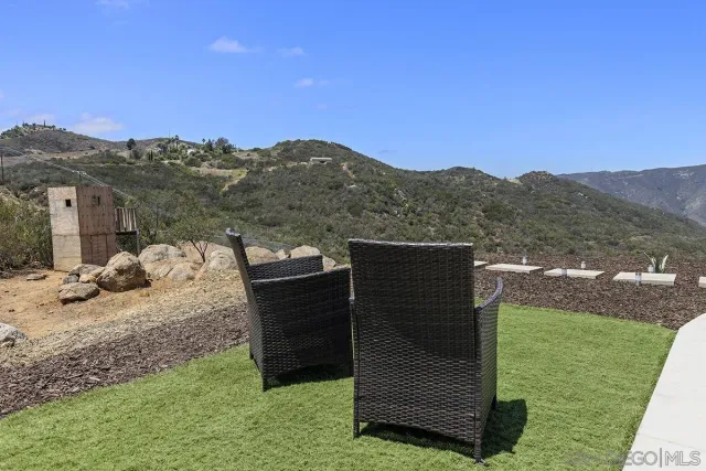 a view of a house with a mountain and a forest