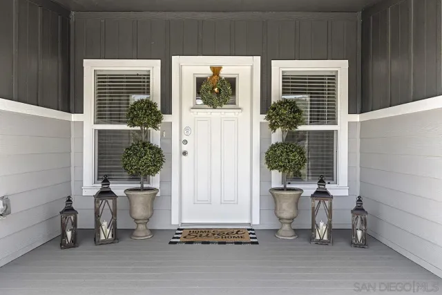 a hallway with white cabinets and wooden floor