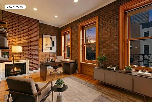 a bedroom with a large bed and a fireplace