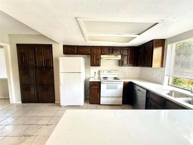 a kitchen with stainless steel appliances a refrigerator sink and cabinets