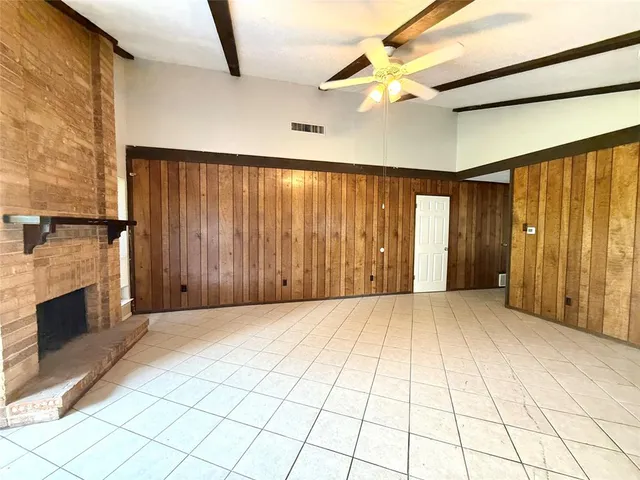 a view of an empty room with a fireplace