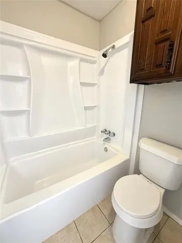 a bathroom with a toilet and a bathtub