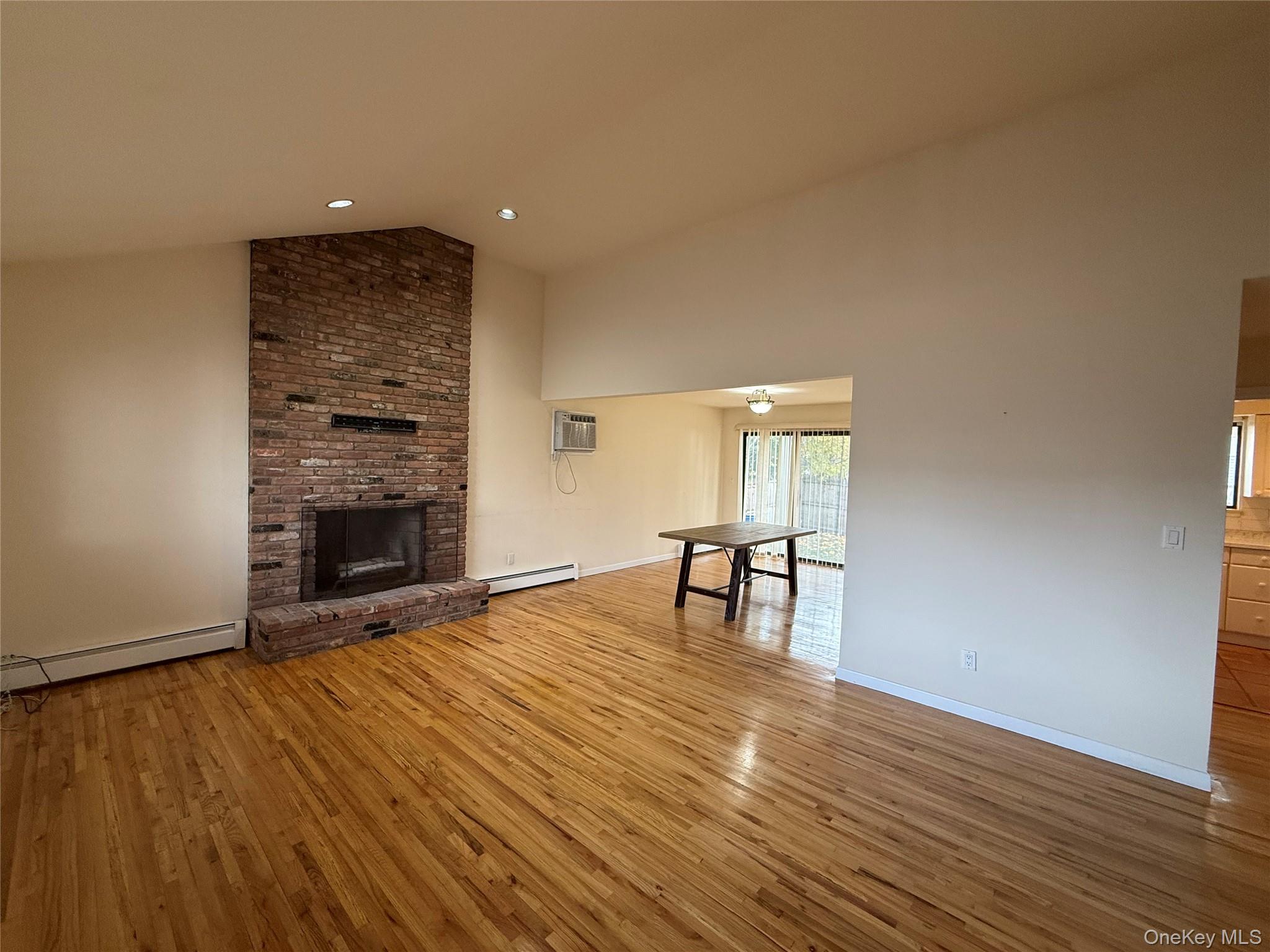 35 A South Norwood Road, Unit A Port Washington, NY 11050 - Photo 1 of 1 a view of empty room with wooden floor and fireplace
